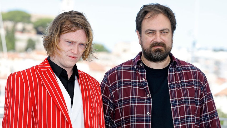 Actor Caleb Landry Jones (in orange) and Director Justin Kurzel attend a photocall for 'Nitram'.