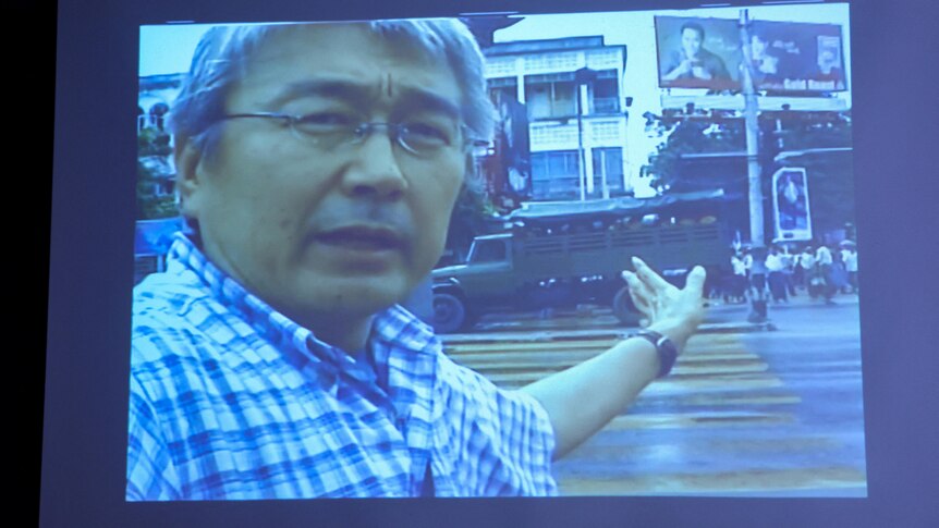 A screen shows unseen footage filmed by slain Japanese journalist Kenji Nagai.