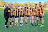 Four mothers and four daughters in Aussie Rules football gear