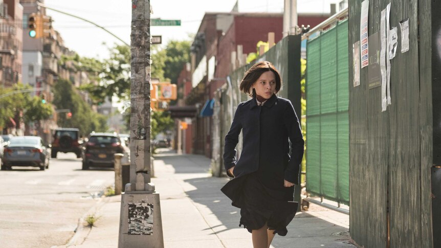 A scene from Unorthodox with Shira Haas as an Orthodox Jewish woman running down a street in New York