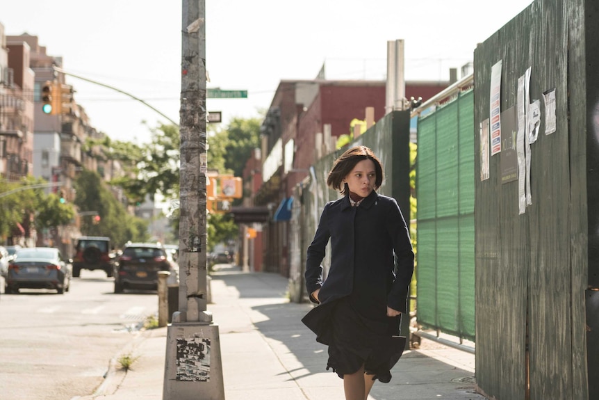 A scene from Unorthodox with Shira Haas as an Orthodox Jewish woman running down a street in New York