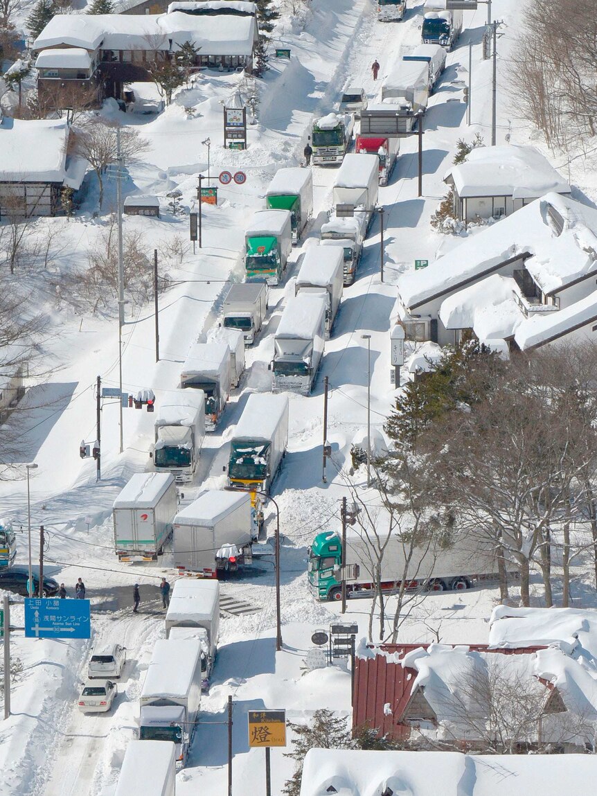 Trucks and cars stranded by heavy snow in Japan