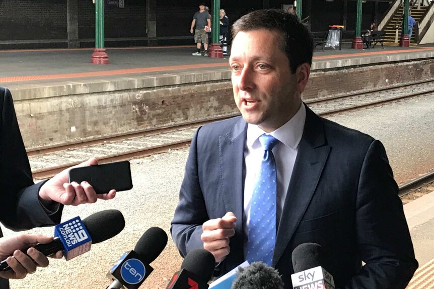 Opposition Leader Matthew Guy speaks to reporters at Geelong Station.