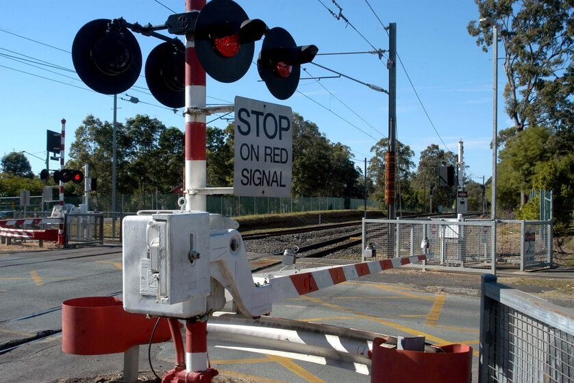 A boom-gate stops traffic at a level suburban level crossing