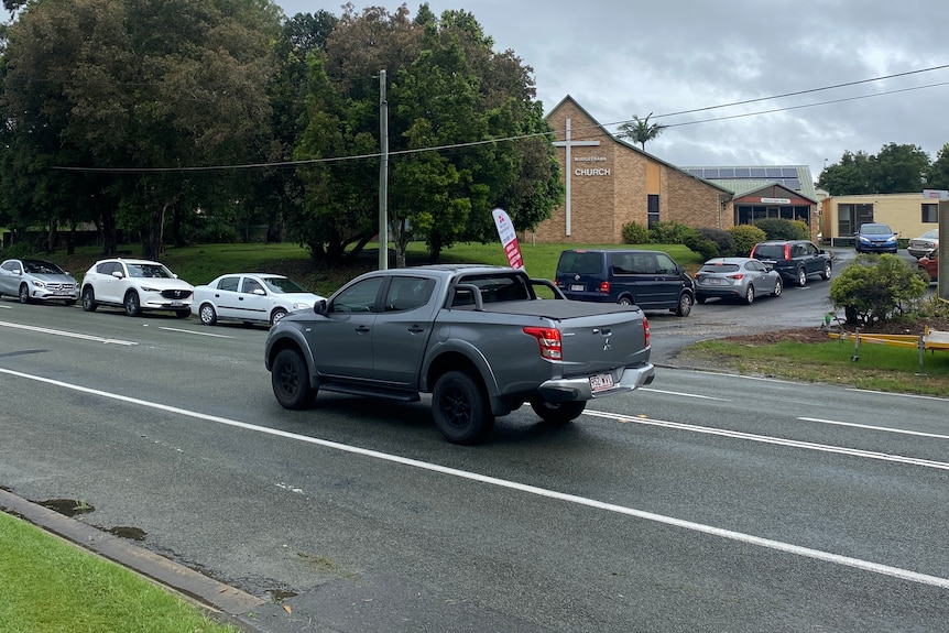 Cars are lined up outside a COVID clinic.