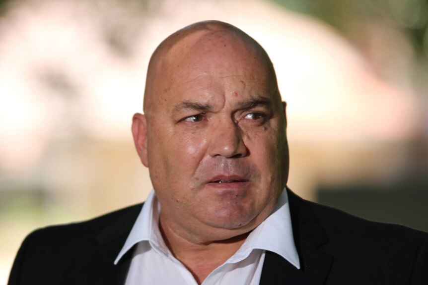 An image of Perth taxi driver Athan Tsirigotis in white shirt and black jacket