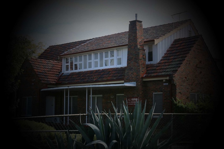 A picture of an older two-storey house with a black shadow around the edges.