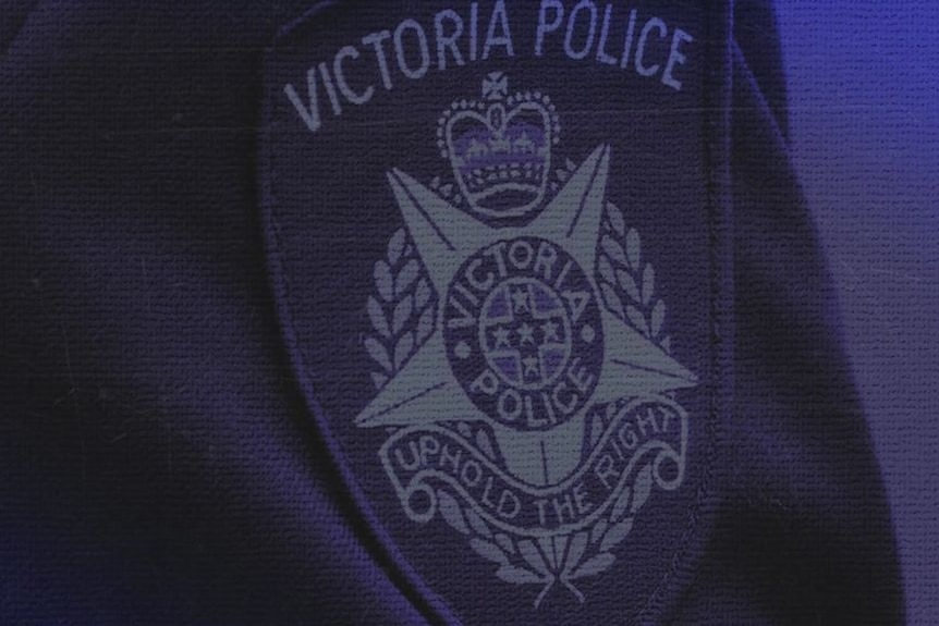 A close-up of a Victoria Police badge on a shirt sleeve.