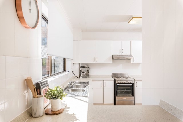 A modern sleek white kitchen in an apartment