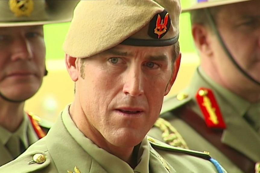 a man wearing army uniform looking