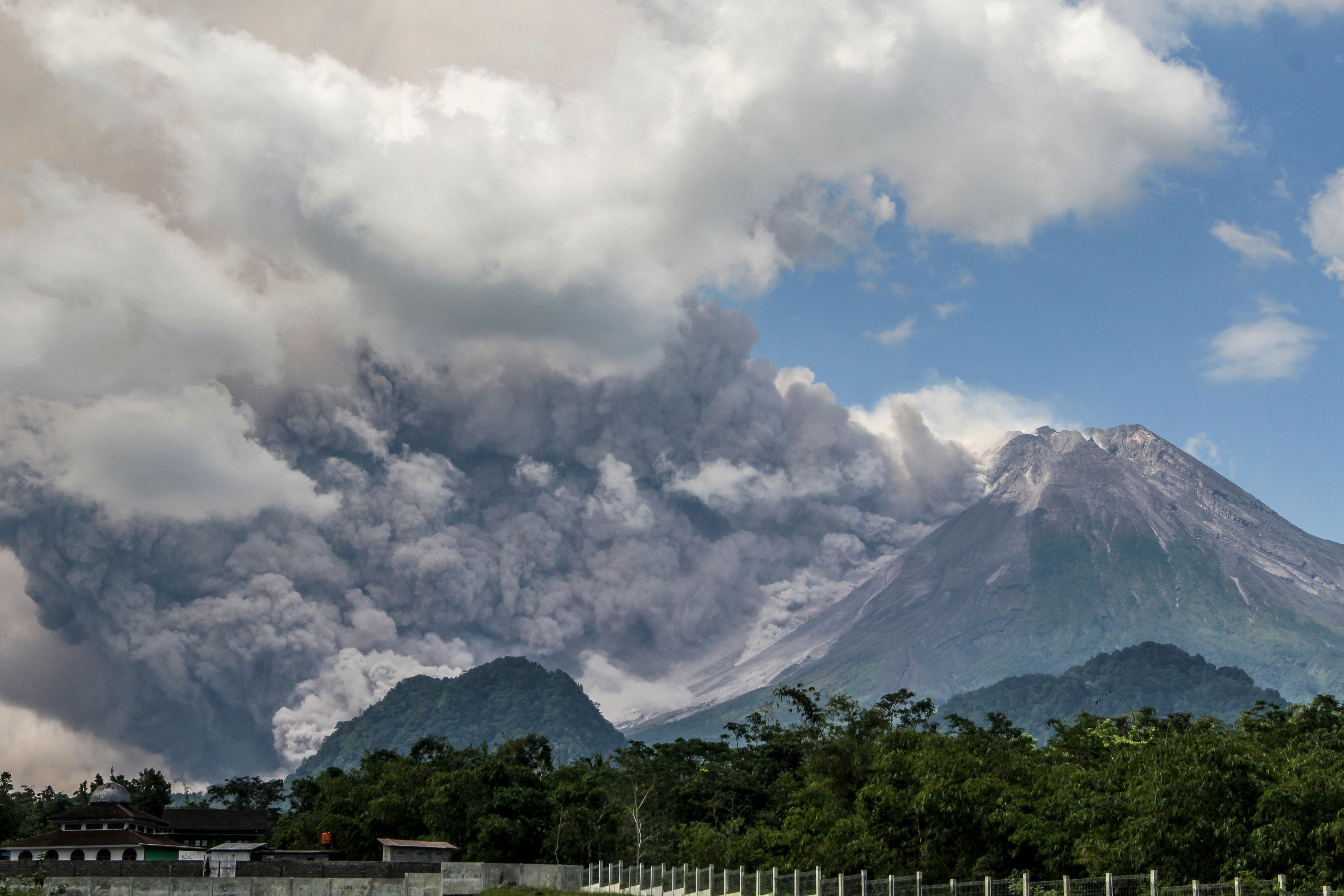 Indonesia's Mount Merapi volcano erupts, spewing hot clouds into the