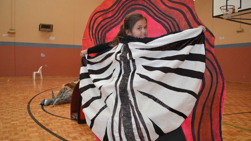 WA Kalgoorlie-Boulder student Lalirra Dane poses in costume as a baby emu in gymnasium.