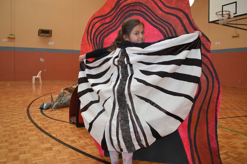 WA Kalgoorlie-Boulder student Lalirra Dane poses in costume as a baby emu in gymnasium.