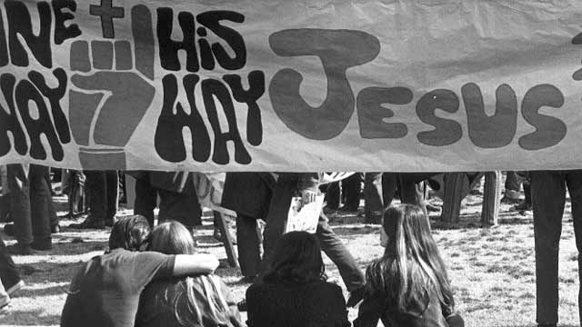 black and white image of young people sitting under a banner that reads 'one way, his way Jesus.'
