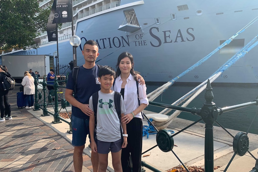 Passengers next to cruise ship