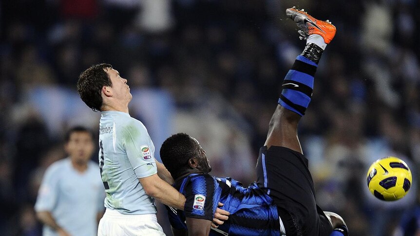 Inter Milan midfielder Sulley Muntari vies with Lazio defender Stephan Lichsteiner.