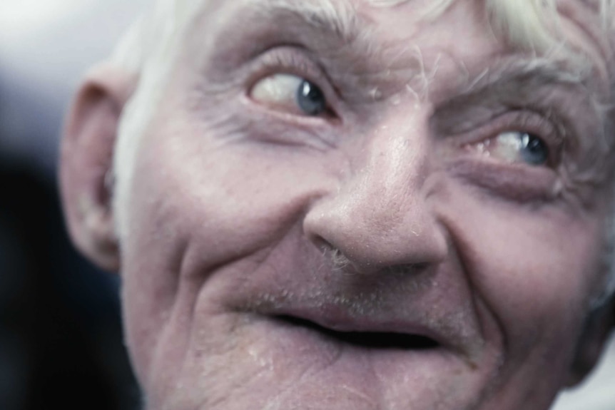 Extreme close up of a man's smiling face.