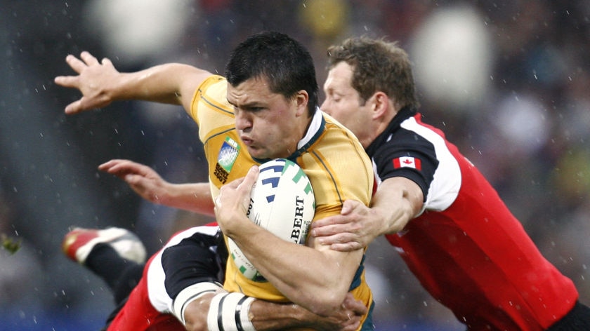 Wallabies centre Adam Ashley-Cooper is tackled by a Canadian defender