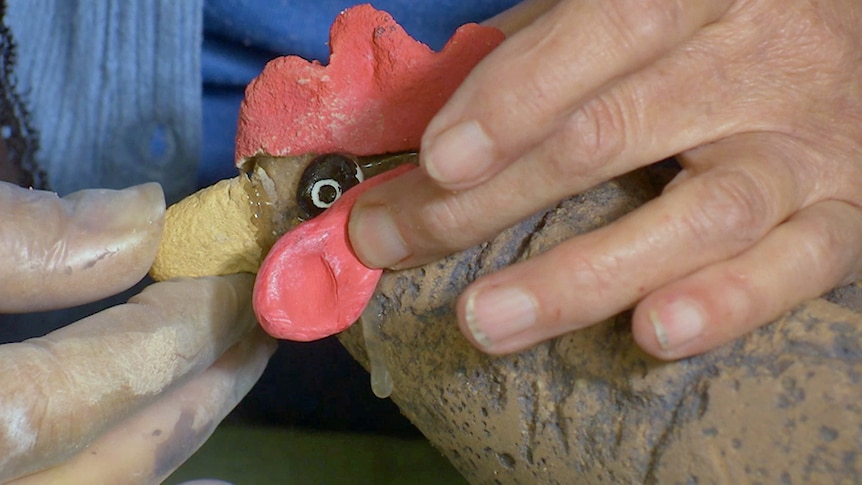 clay beak being attached to chook ornament