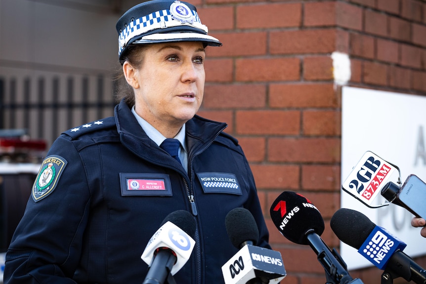 A female police officer addresses the media
