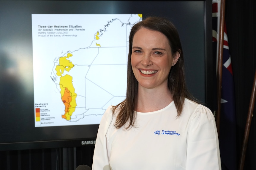 A woman stands in front of a map of Western Australia showing a weather forecast.