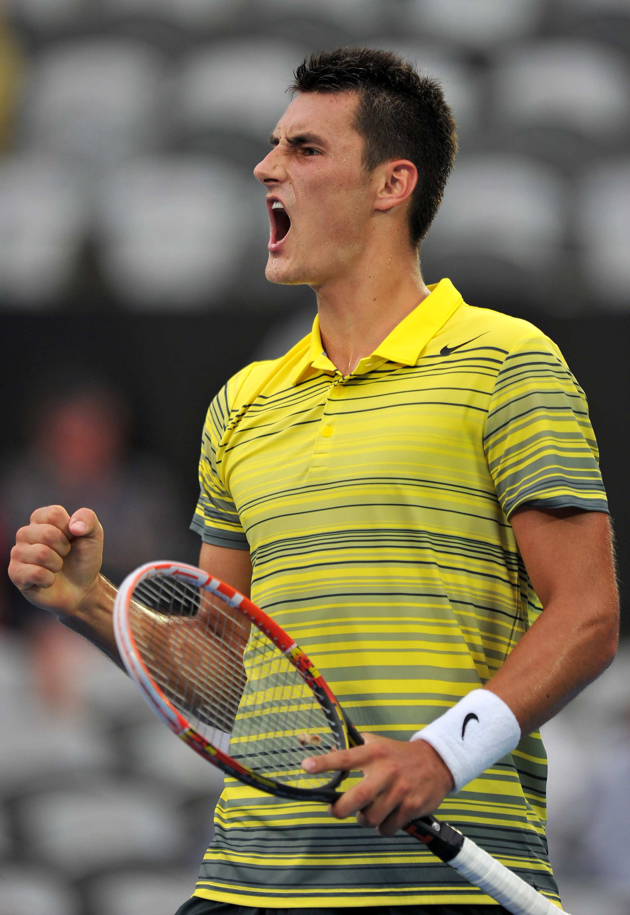 Bernard Tomic wins in three sets to keep Sydney International title
