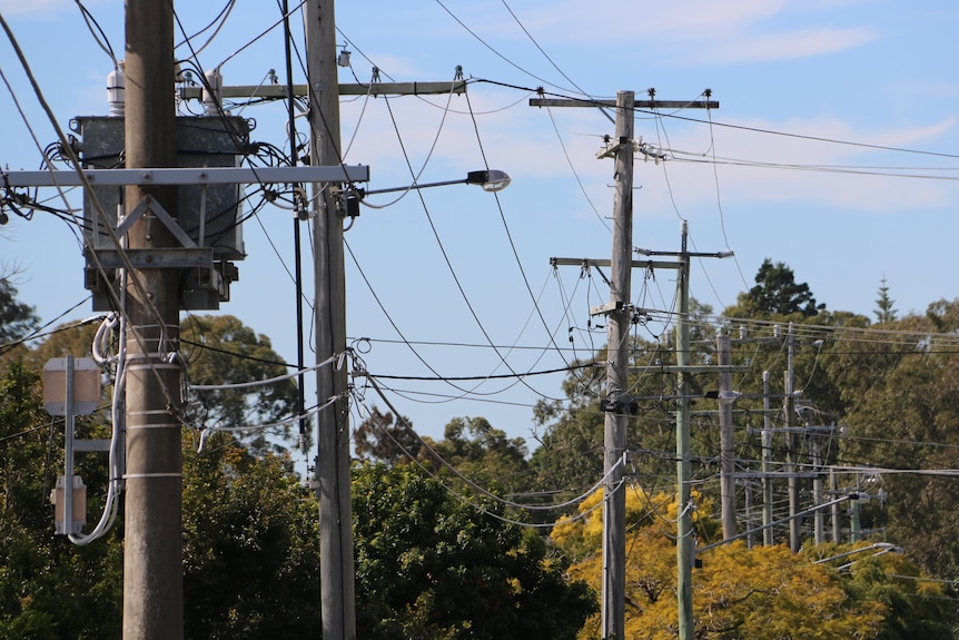 Powerlines stretching across a blue sky. 