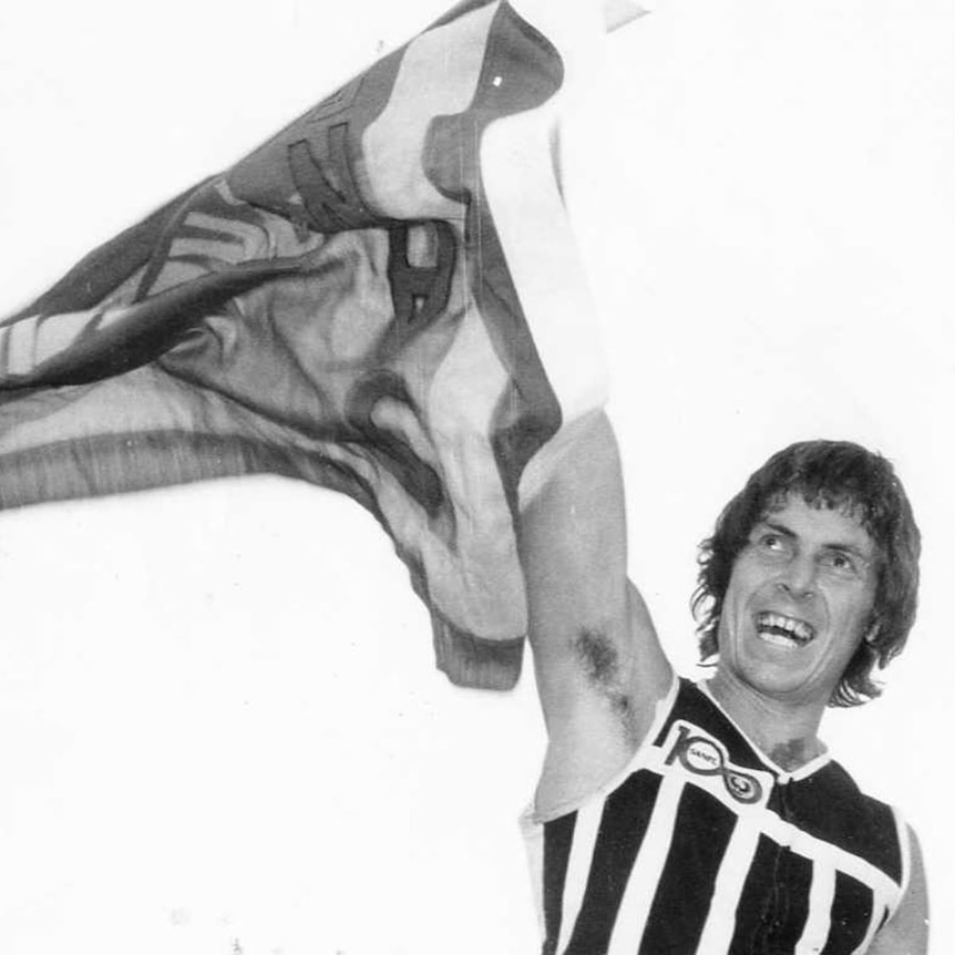 Port Adelaide's Russell Ebert holds a premiership flag