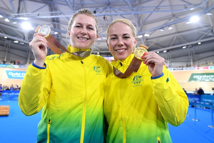 Stephanie Morton and Kaarle McCullough hold up their medals.