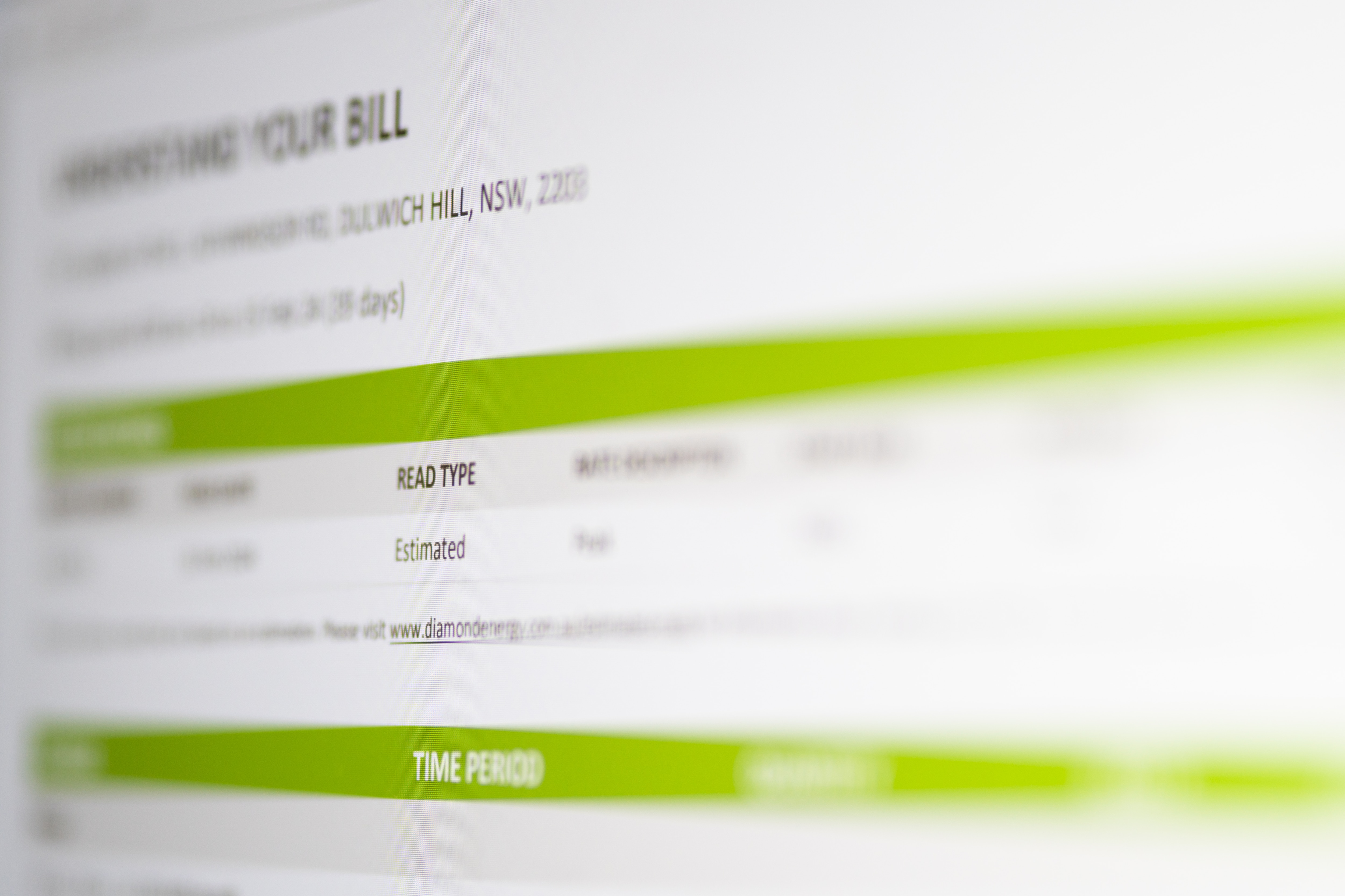 Black writing on a white piece of paper with green reflections