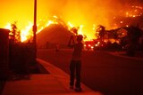 'Perfect storm' ... a resident takes photos as fire nears homes in Yorba Linda, California.