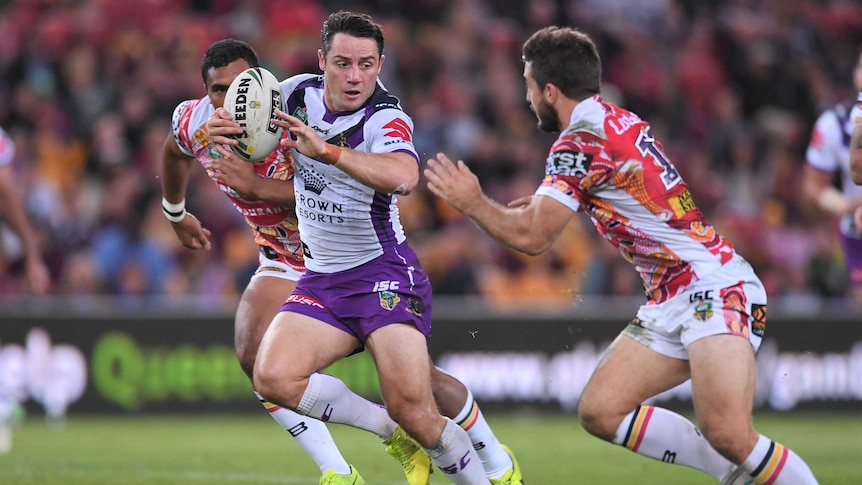 Cooper Cronk of the Melbourne Storm runs with the ball against the Brisbane Broncos.