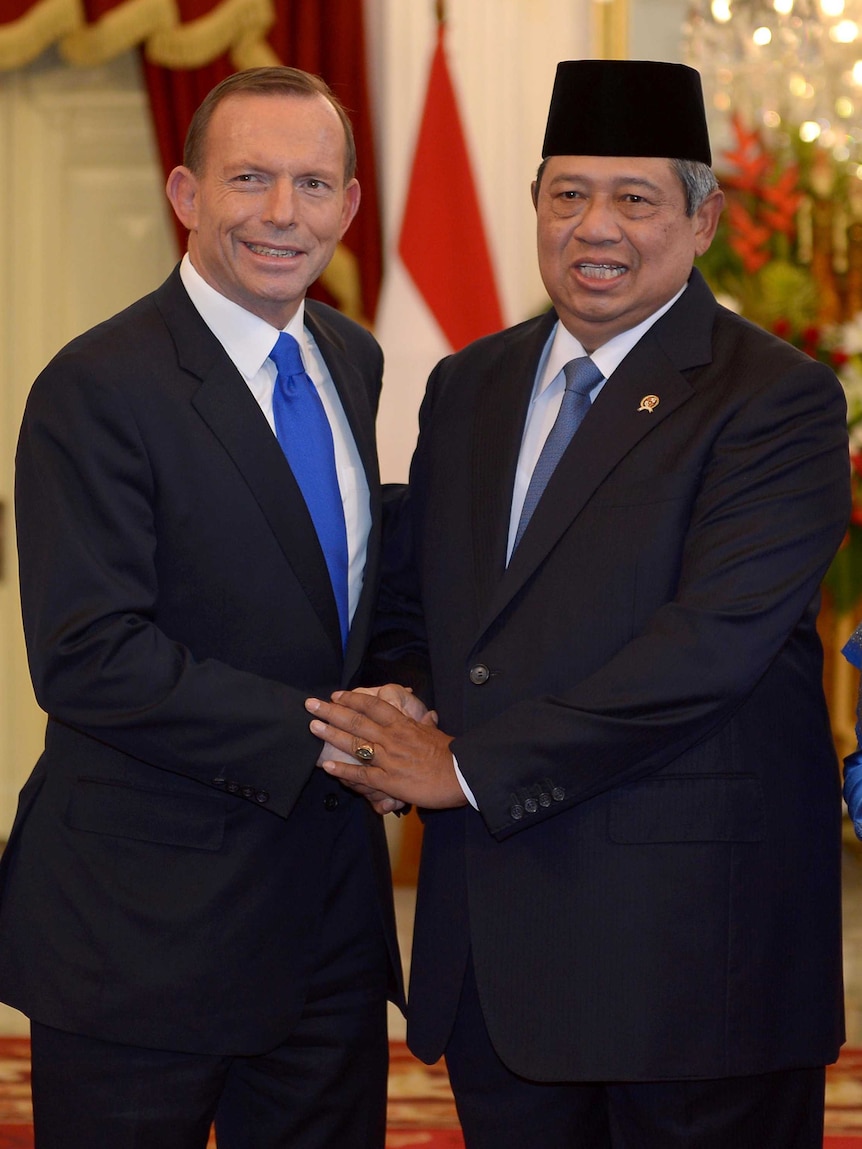 Tony Abbott shakes hands with Susilo Bambang Yudhoyono at the presidential palace in Jakarta.