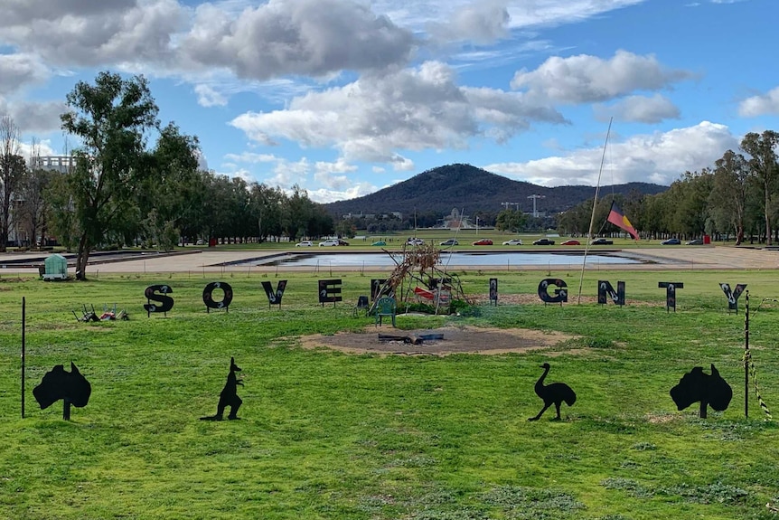 The word Sovereignty is spelled out at the Aboriginal Tent Embassy.