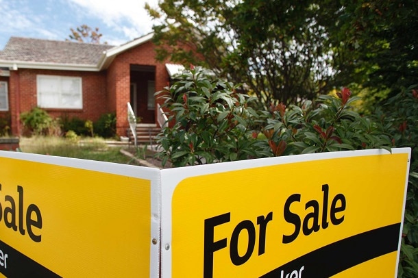 A for sale sign outside a house.