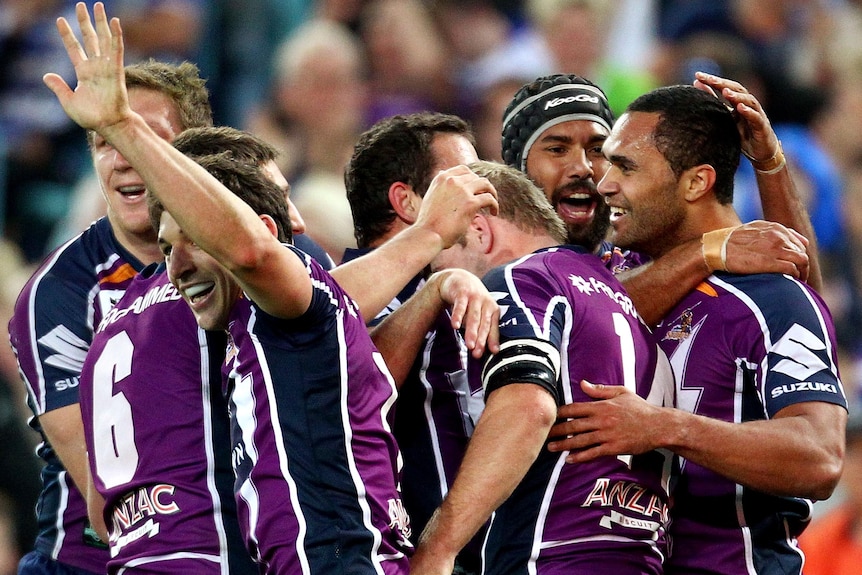 Storm players celebrate a try during the 2012 NRL grand final.