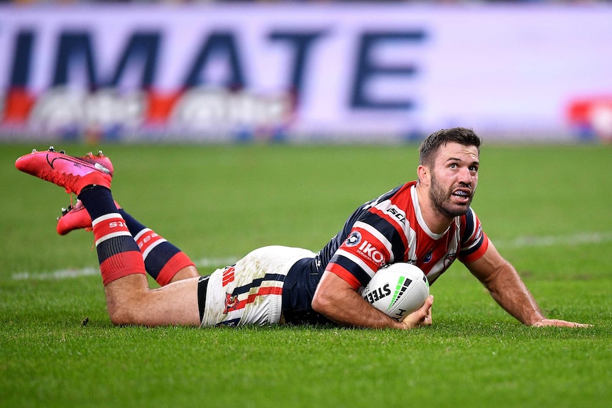 A Sydney Roosters NRL player looks up from the ground after scoring a try against the Canterbury Bulldogs.