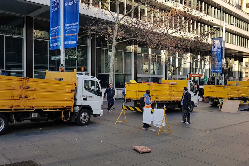 Yellow trucks parked in Martin Place.