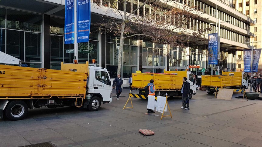 Yellow trucks parked in Martin Place.