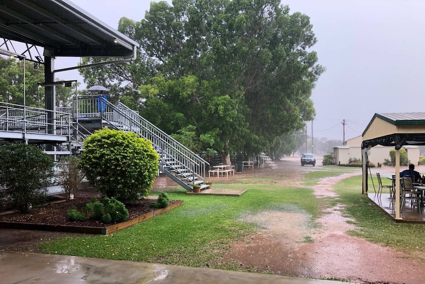 Puddles form as much-needed rain falls at the Blackall Cattle Saleyards