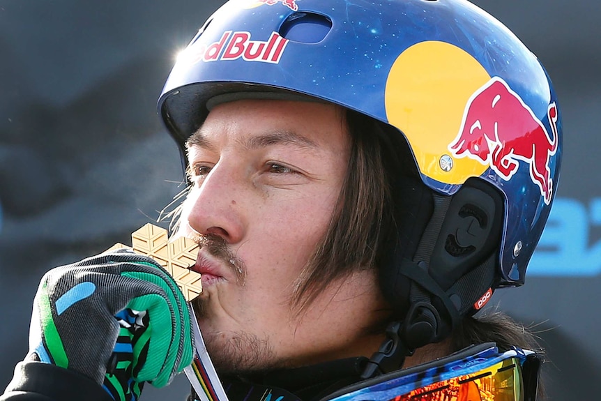 Australian snowboarder Alex Pullin kisses his gold medal at the 2013 snowboard world championships.