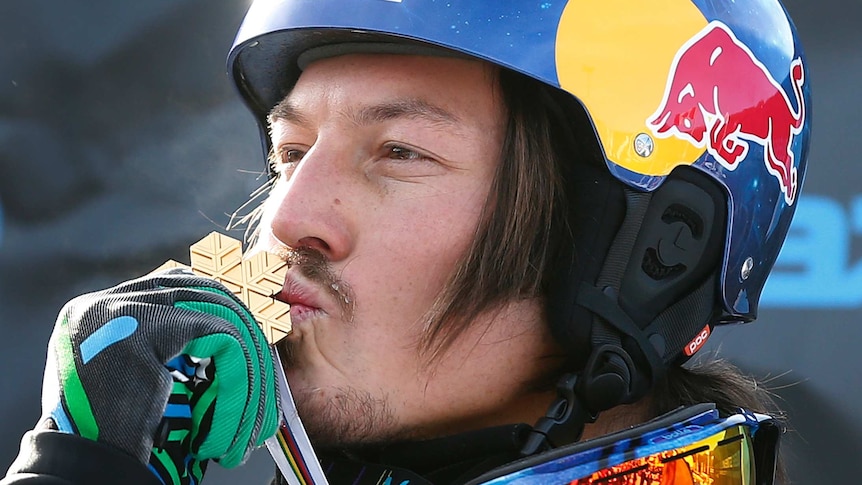 Snowboarder Alex Pullin kisses his gold medal at the 2013 snowboard world championships.