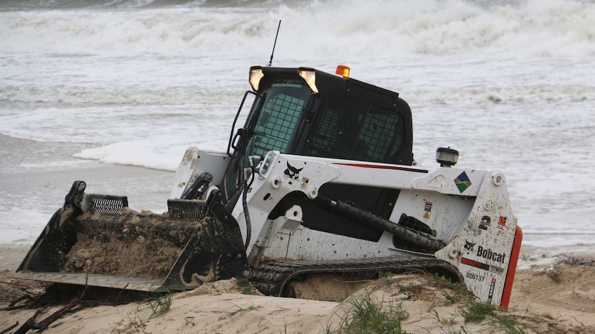 Bobcat working to protect sand dunes at West Beach during storms