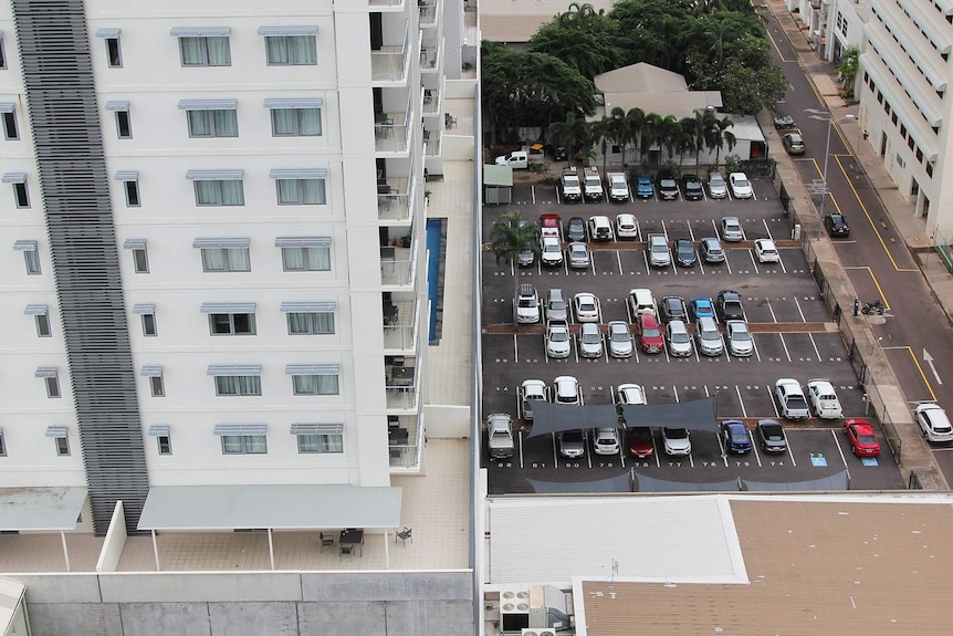 An aerial photo of Darwin city featuring a big carpark and an apartment.