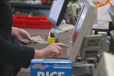 Video still: Generic shopping photo of hand with money at electronic self service supermarket checkout Aug 2012