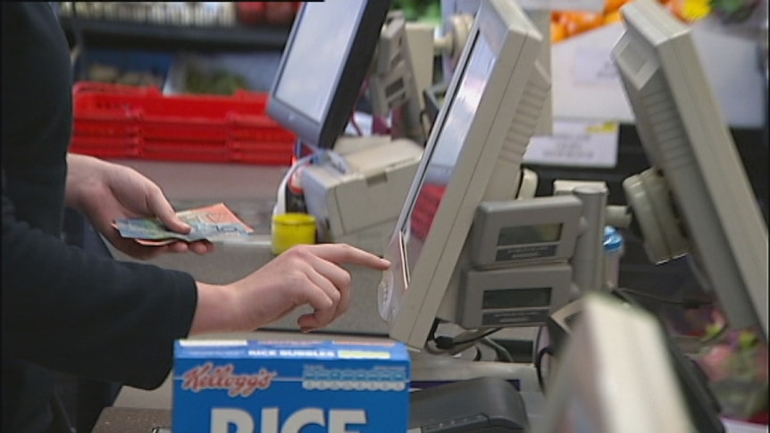 Video still: Generic shopping photo of hand with money at electronic self service supermarket checkout Aug 2012