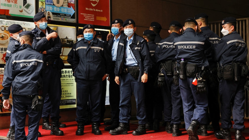 Police are seen outside the Stand News office building.