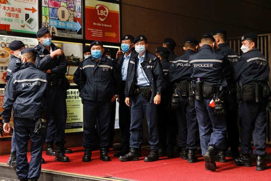 Police are seen outside the Stand News office building.