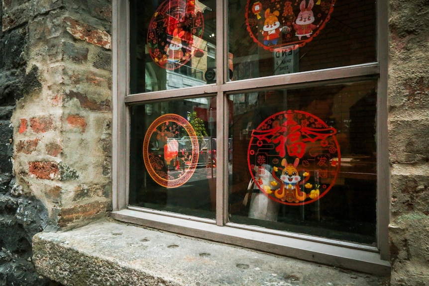 An artistic photo of a window looking into a restaurant in Melbourne's Chinatown.