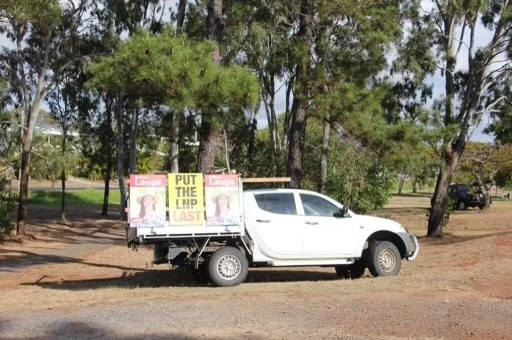 Campaign corflute signs for Labor's Brittany Lauga next to one that says put the LNP last